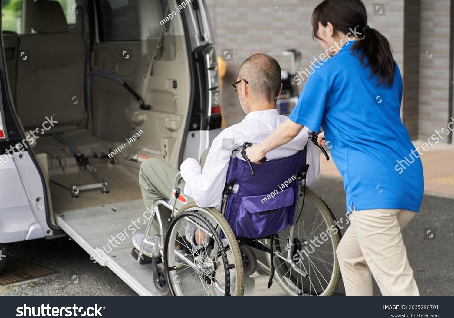 stock-photo-a-caregiver-who-puts-an-elderly-person-in-a-long-term-care-taxi-2035290701