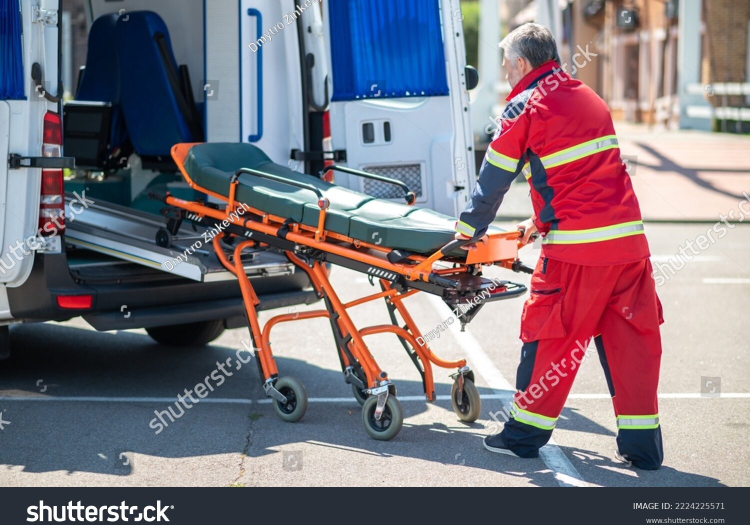 stock-photo-paramedic-taking-the-gurney-out-of-the-ambulance-van-2224225571