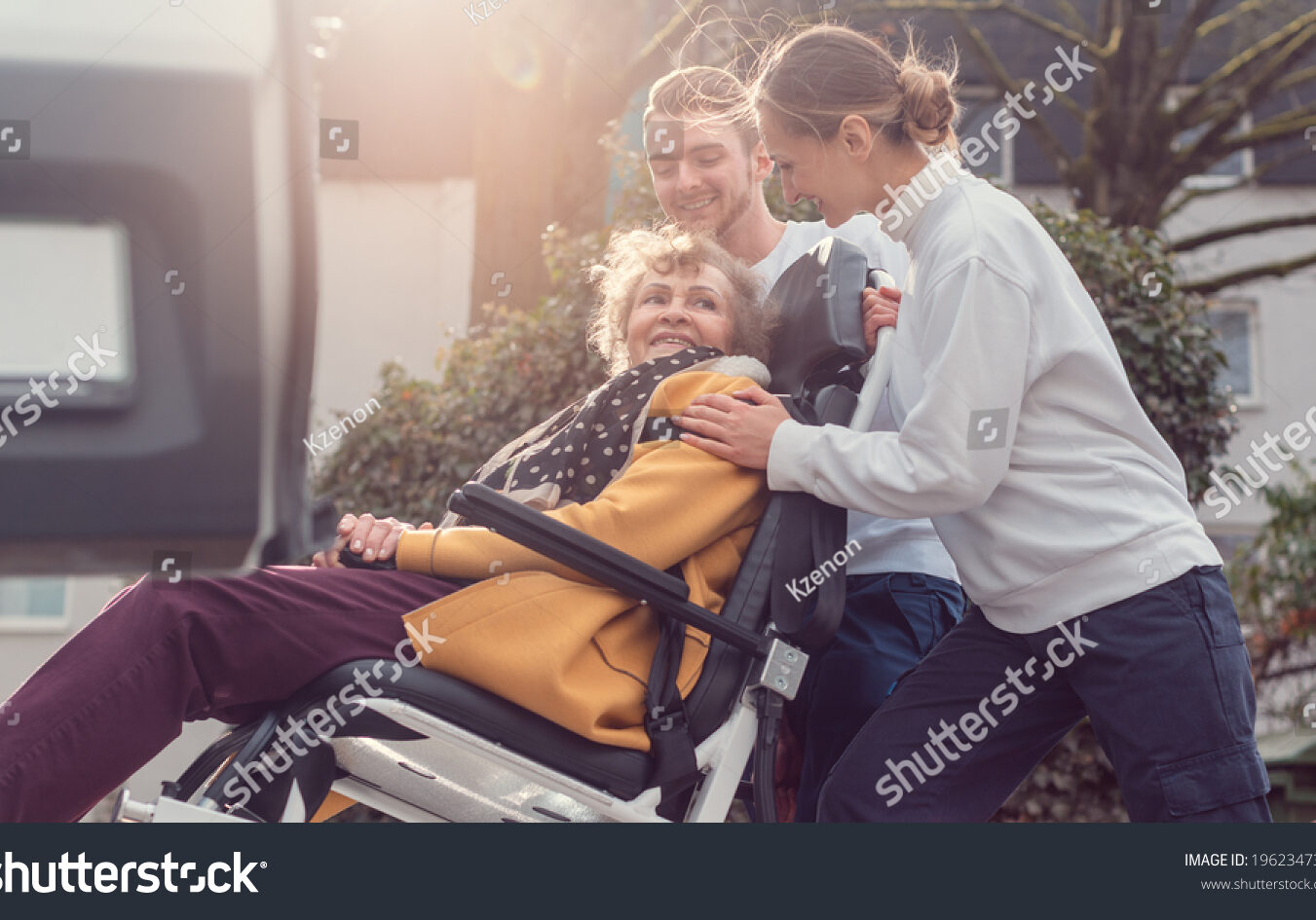 stock-photo-two-helpers-picking-up-disabled-senior-woman-for-transport-1962347317